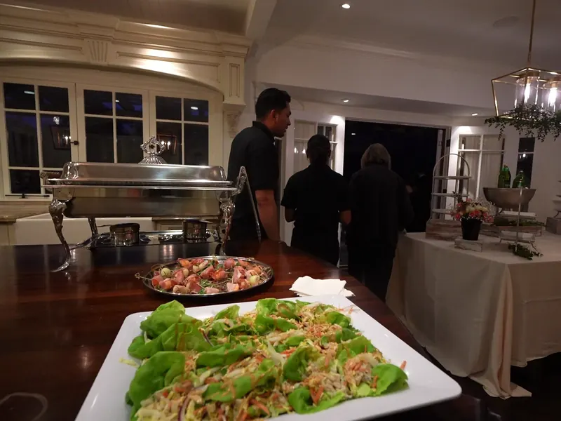 Lettuce wrap platter beside chafing dishes at a catered Walnut Creek dinner