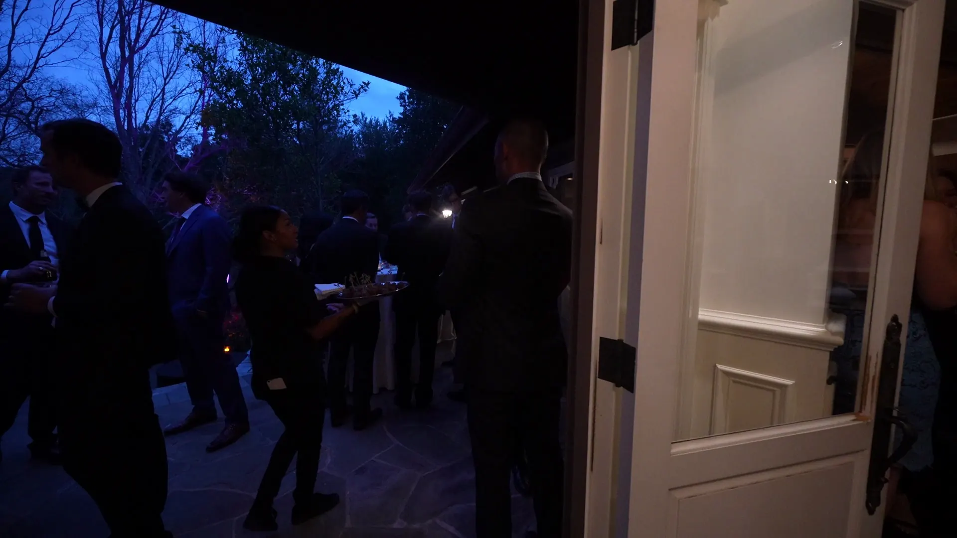 Guests gathered on a patio at dusk during a catered Concord event