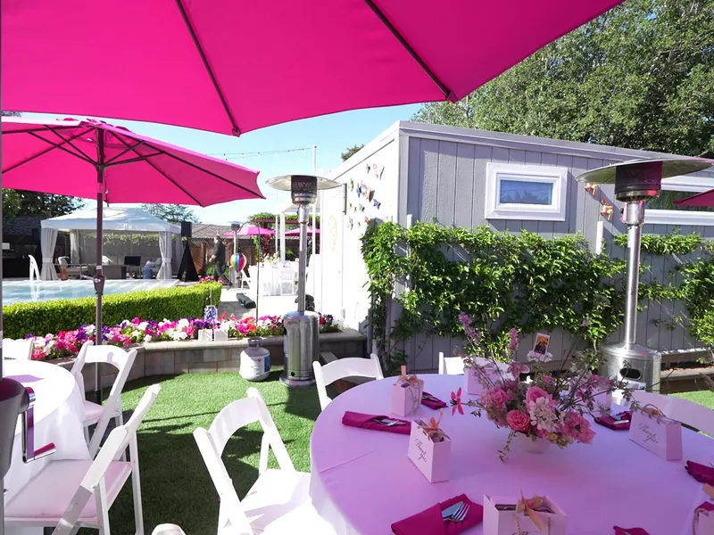 Patio heaters and umbrella seating at an evening Alamo party