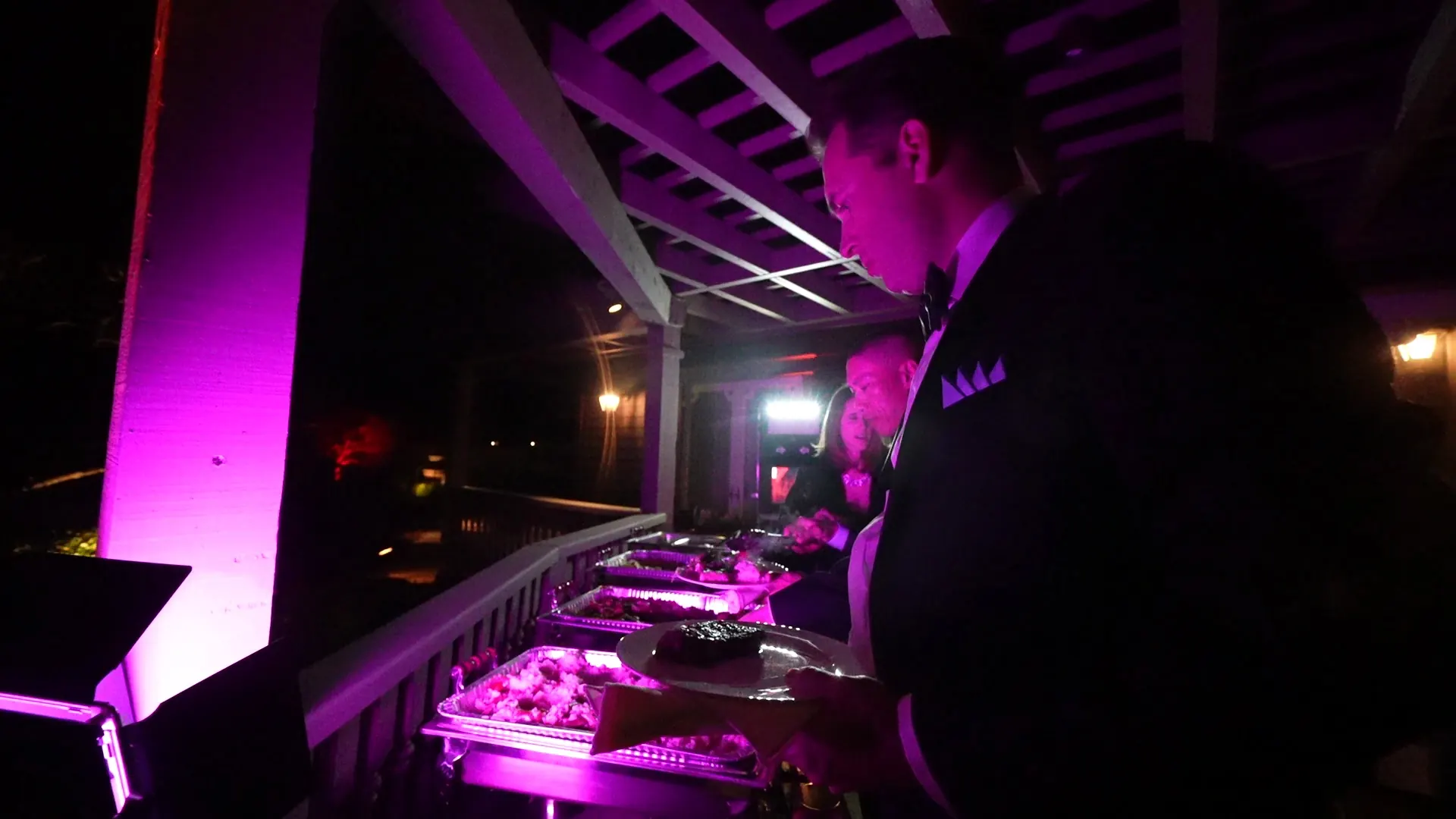 Buffet line set under a pergola with evening lighting in Pleasant Hill