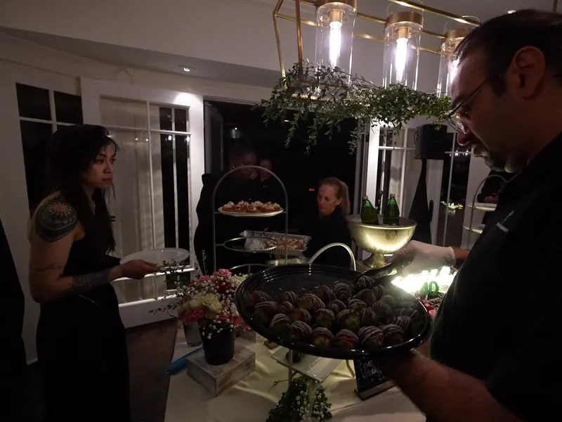 Server offering a tray of truffles at an Oakley evening event