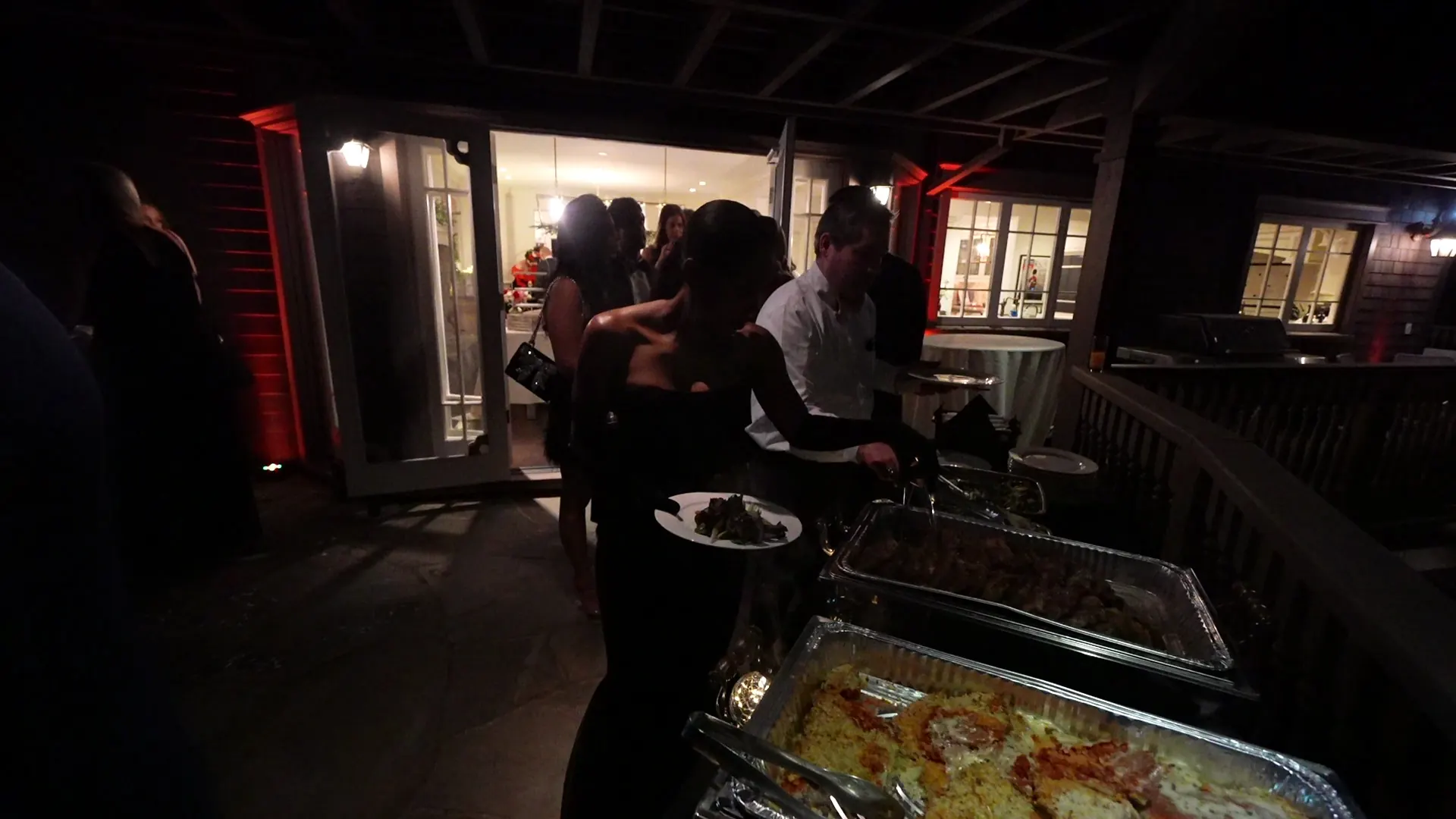 Guests serving themselves from a hot buffet at an evening Antioch event