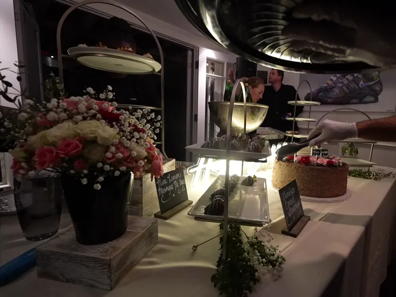 Dessert table trimmed with roses at an Oakley celebration