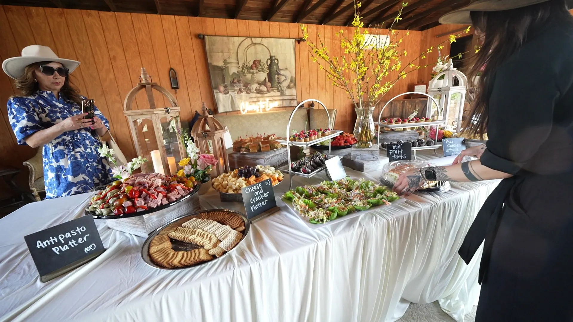 Long antipasto display table with breads and cheeses at a Danville event