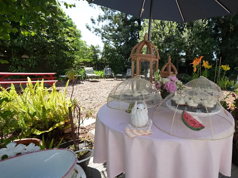 Dessert table with glass cloches set in an Antioch garden
