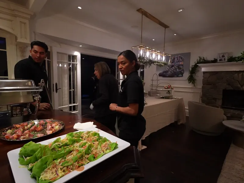 Staff plating lettuce wraps in the kitchen at a Concord dinner party