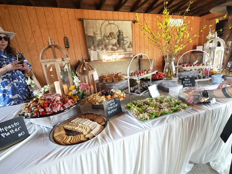 Antipasto grazing table with cheeses, fruit, and crackers at a Martinez party