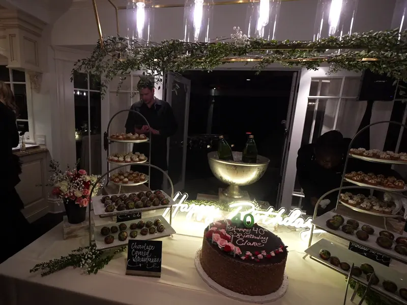 Birthday cake and dessert table trimmed with greenery at a Moraga party